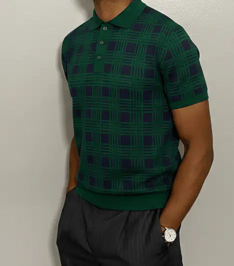 Person wearing a Green and navy plaid pure BCI Cotton polo shirt against a plain background