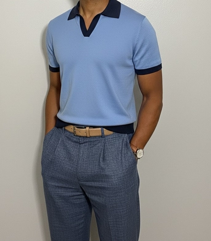 ight blue polo shirt with dark collar and cuffs on a neutral background