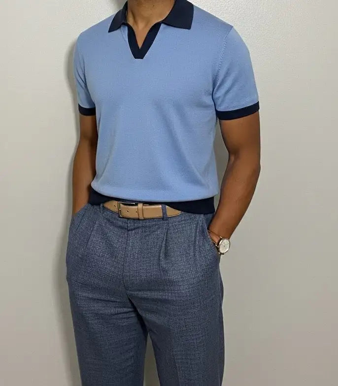 ight blue polo shirt with dark collar and cuffs on a neutral background