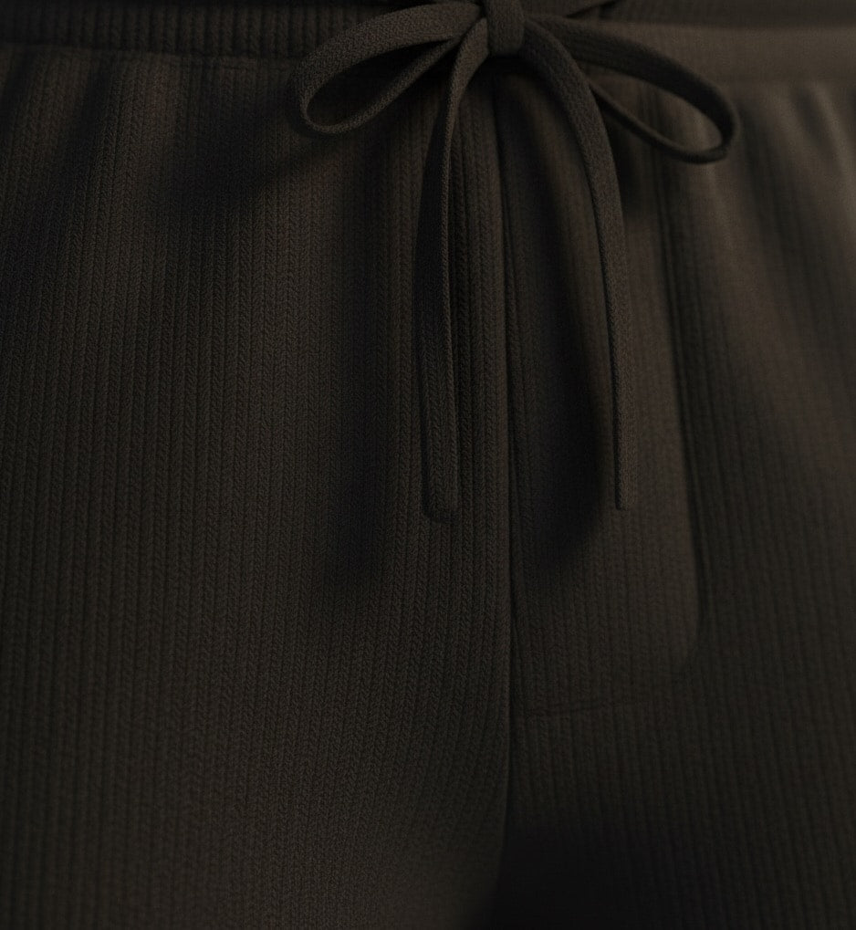 Black pure BCI Cotton shorts on a white background with a tie detail on a matching background