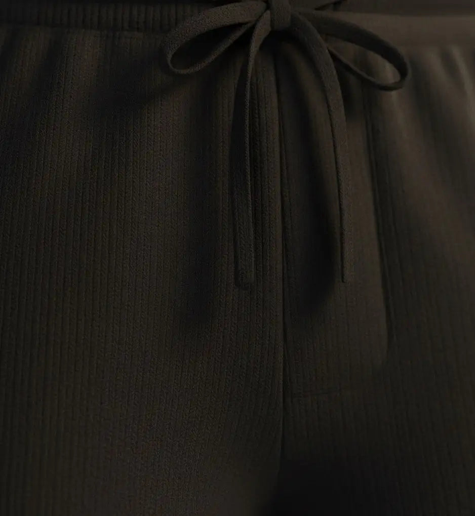 Black pure BCI Cotton shorts on a white background with a tie detail on a matching background