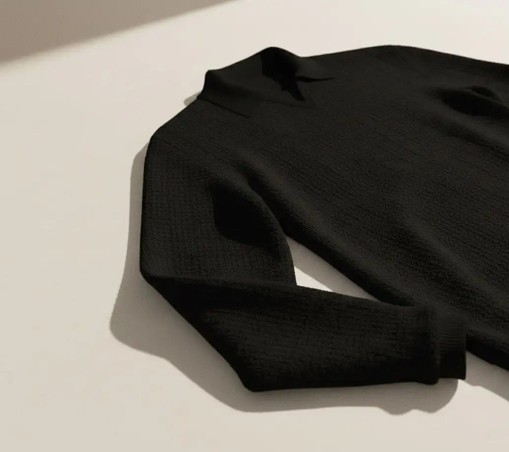 Black long sleeve v-neck Jacquard knit polo on a light beige background