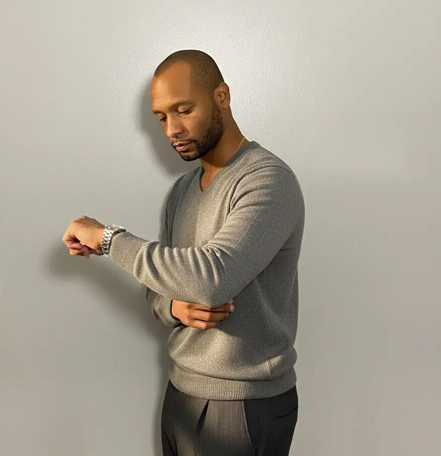 Man wearing a Gray RWS Merino Wool sweater on a white background against a plain background