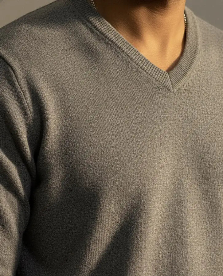 Close-up of a person wearing a Gray RWS Merino Wool sweater on a white background with a neutral background