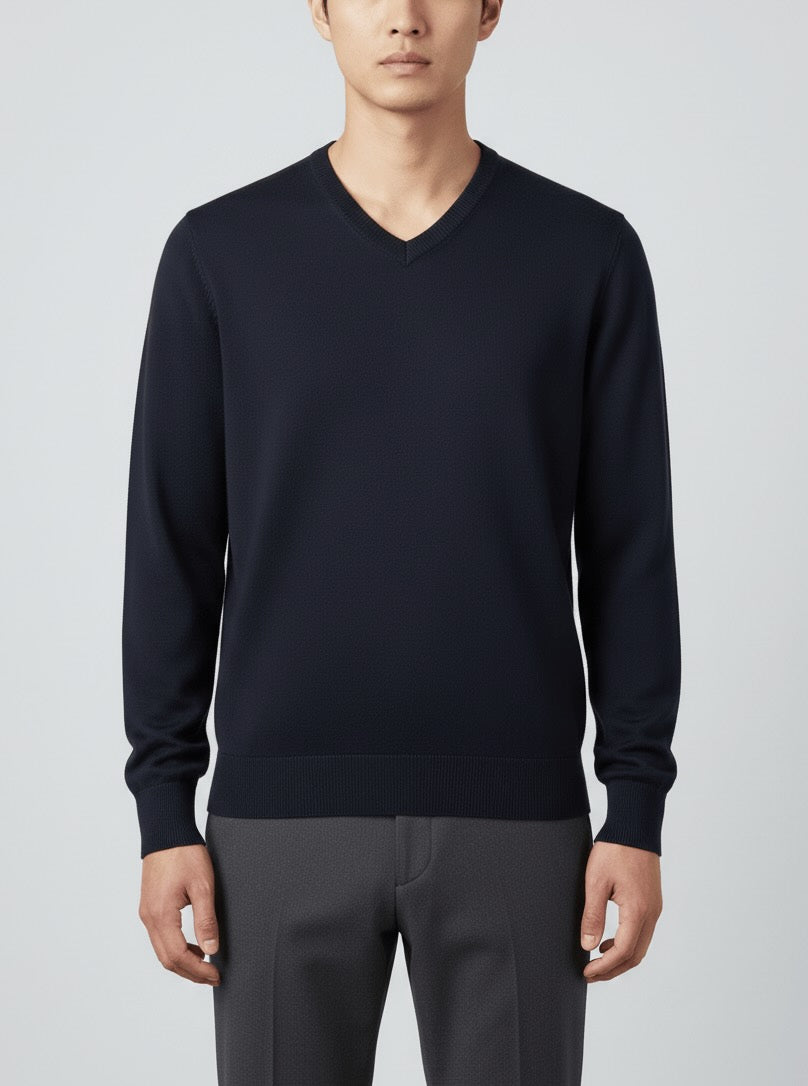 Man wearing a Navy blue RWS Merino Wool V-neck and gray pants on a light gray background