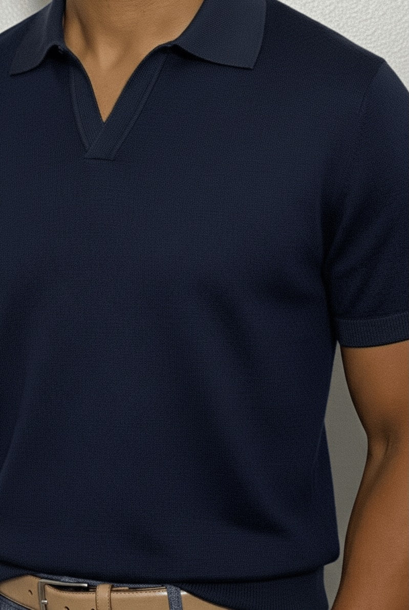 Navy blue polo shirt worn by a person against a neutral background