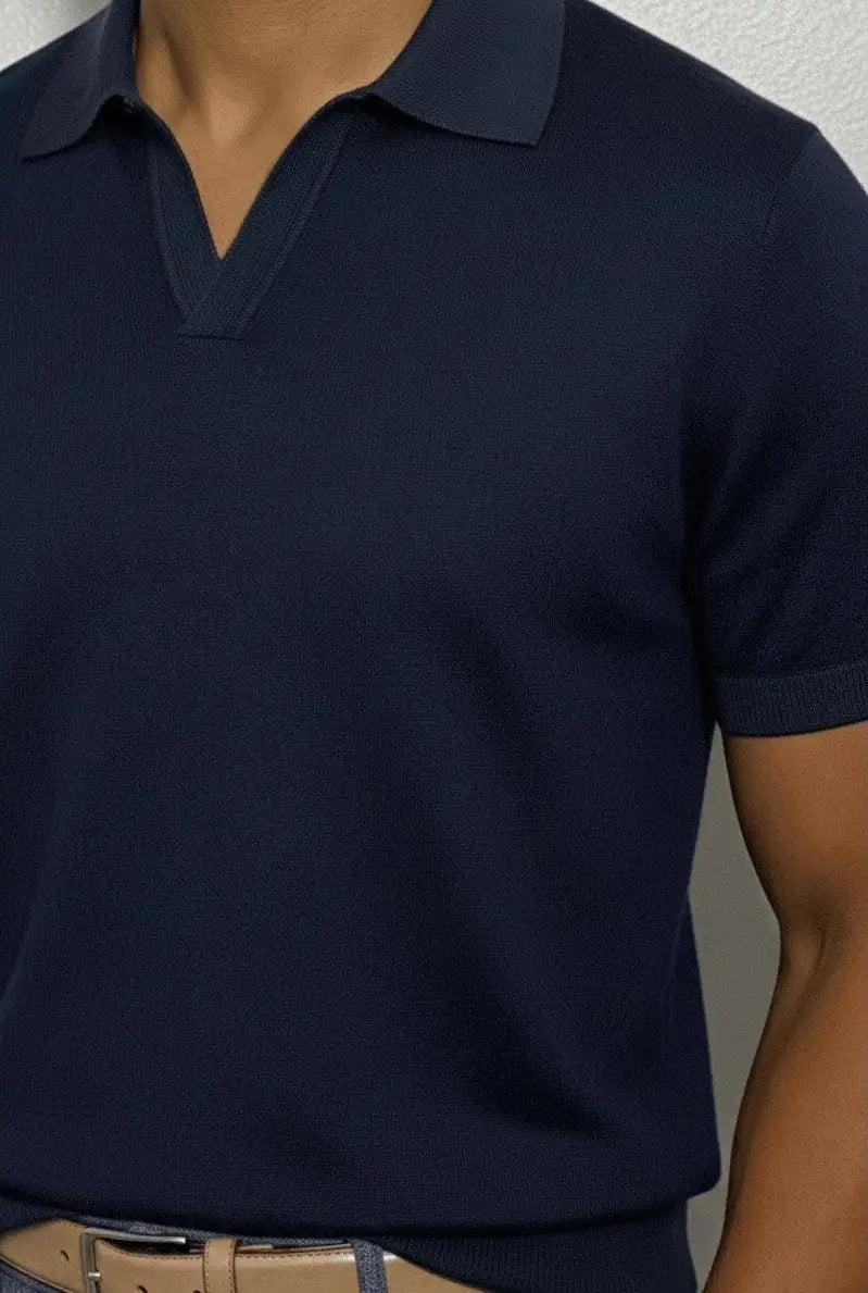 Navy blue polo shirt worn by a person against a neutral background