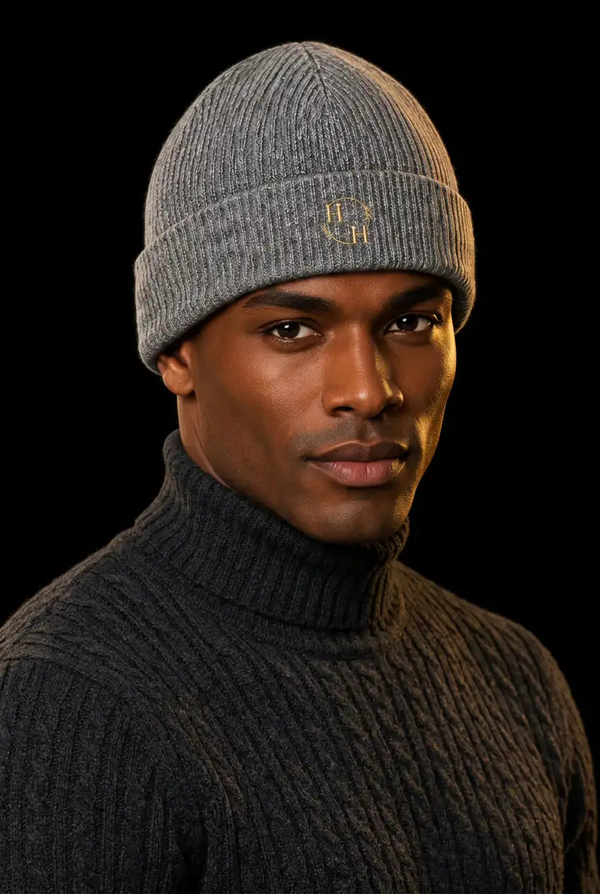Heather-grey beanie editorial portrait with the Nero cable-knit turtleneck